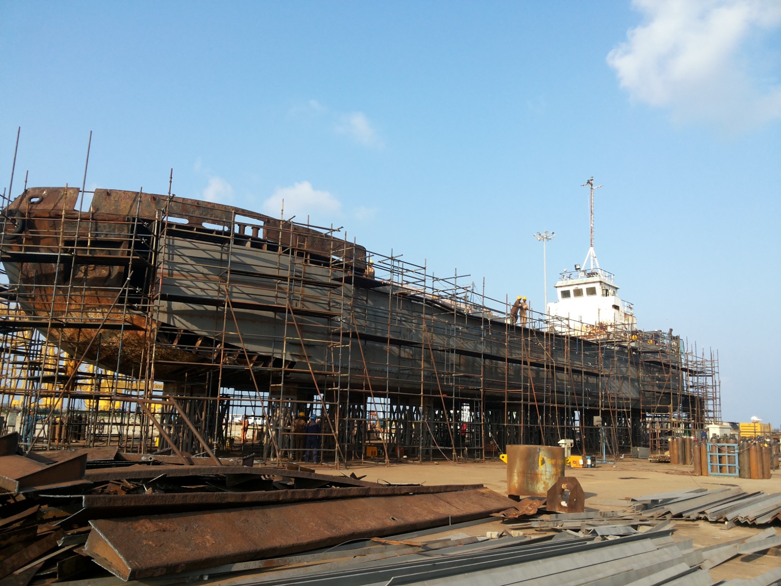 Shipbuilding yard with a vessel under construction and scaffolding in place